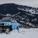 Blizzard Blue Nissan Armada Tows Track-Equipped Nissan 370Zki