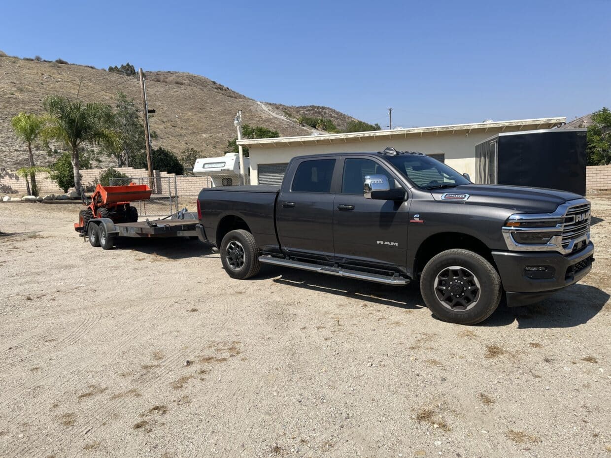 Ram 2500 pulling trailer unloading tractor