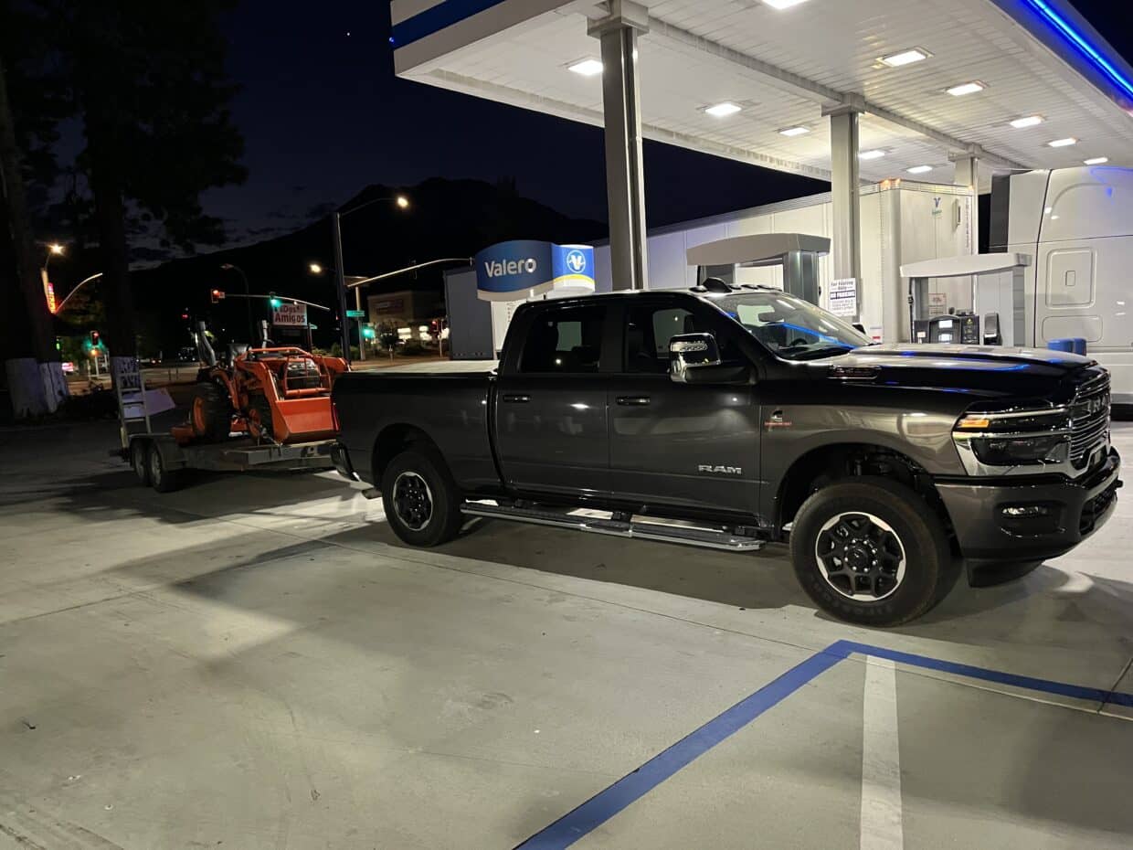 Ram 2500 owing tractor parked at fuel pump