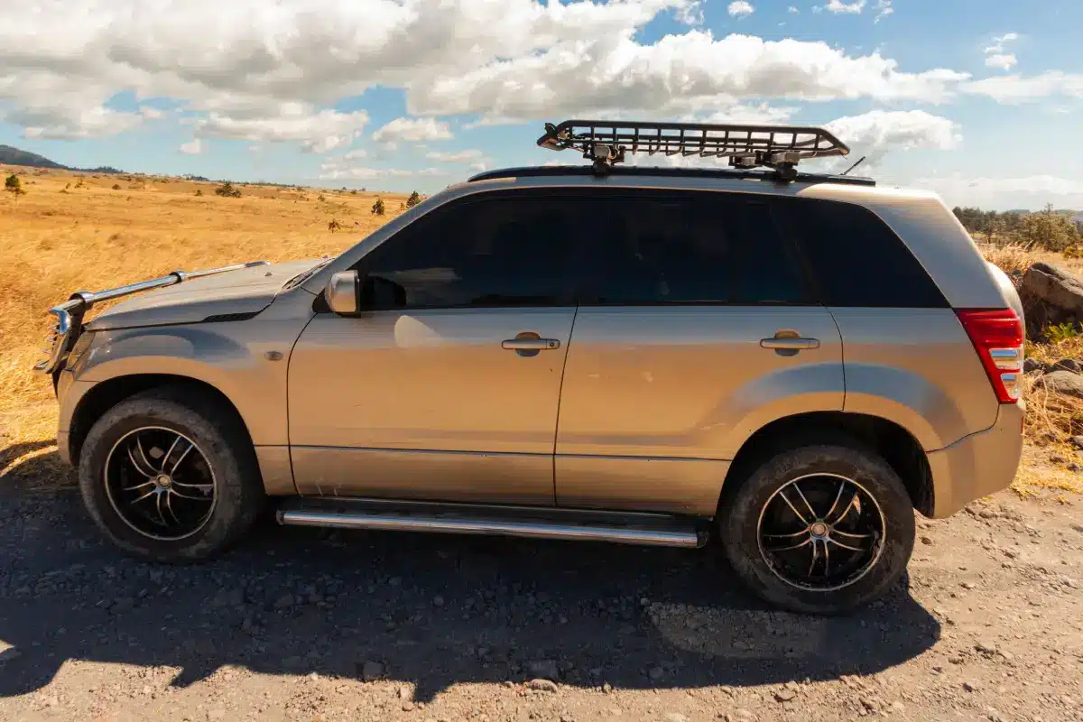 SUV with a roof rack. Photo Courtesy of Pexels: https://www.pexels.com/photo/silver-car-on-a-desert-15887333/