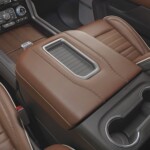 The full grain leather trim washes over the center console storage area.