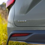 Close-up view of Trax badge on Chevrolet Trax ACTIV in Cacti Green. Pre-production model shown. Actual production model may vary. Available in spring 2023. Cacti Green exterior color late availability.